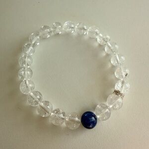 Clear crystal bracelet with a single deep-blue accent bead